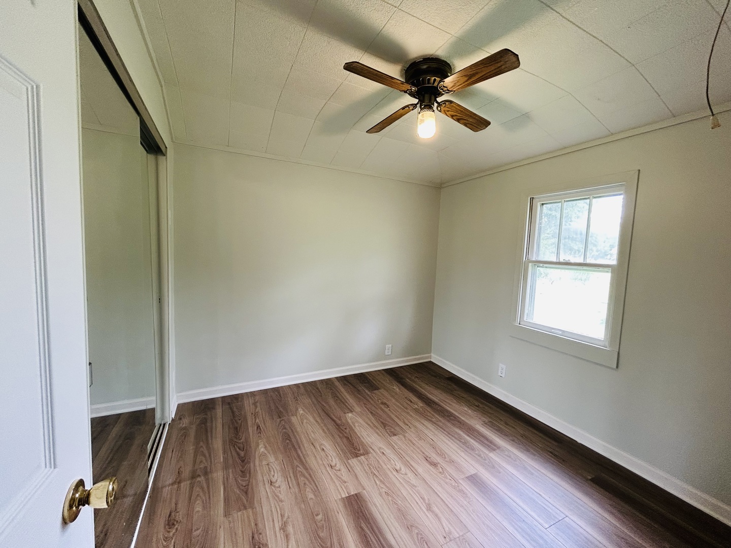 37706 North Nippersink Place Spring Grove, IL 60081 - Photo 9 of 18 an empty room with wooden floor fan and windows