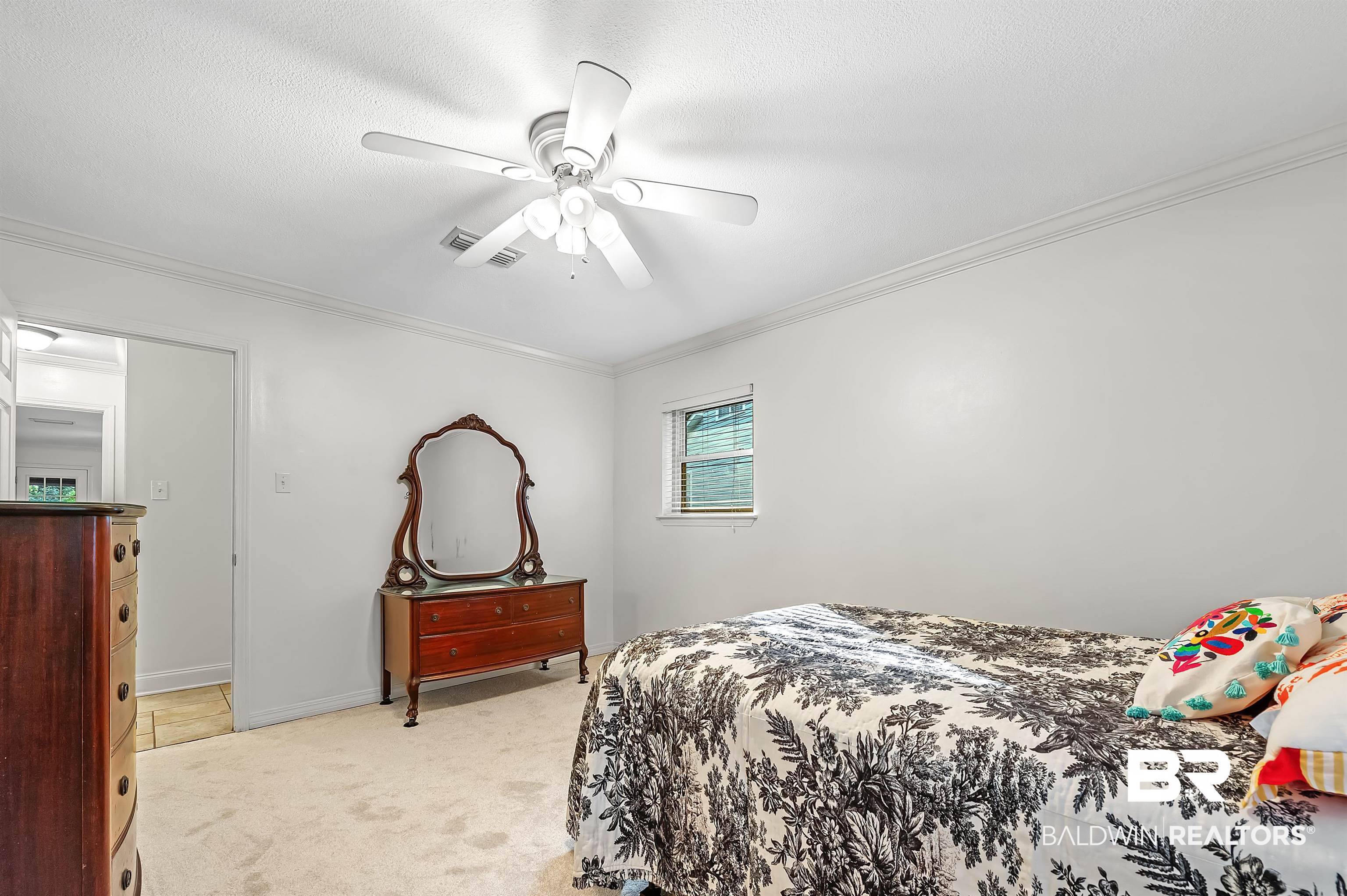 104 James Circle Daphne, AL 36526 - Photo 53 of 62 Carpeted bedroom with ceiling fan and ornamental molding
