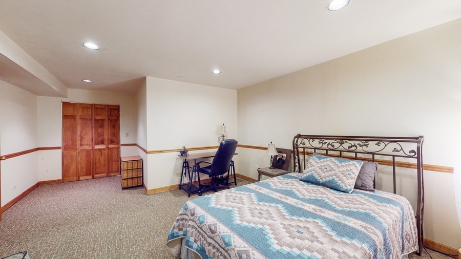 43375 Hunt Club Road Zion, IL 60099 - Photo 17 of 56 a bedroom with a bed and a table