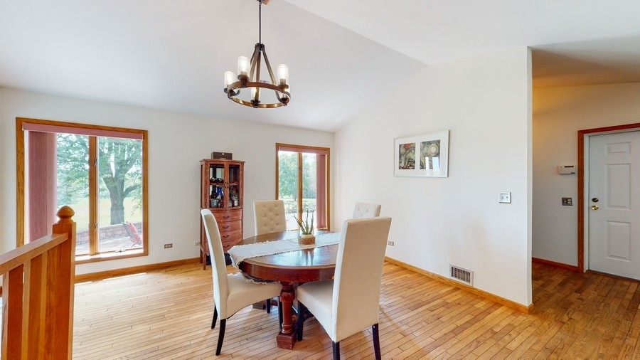 43375 Hunt Club Road Zion, IL 60099 - Photo 6 of 56 a view of a dining room with furniture window and wooden floor
