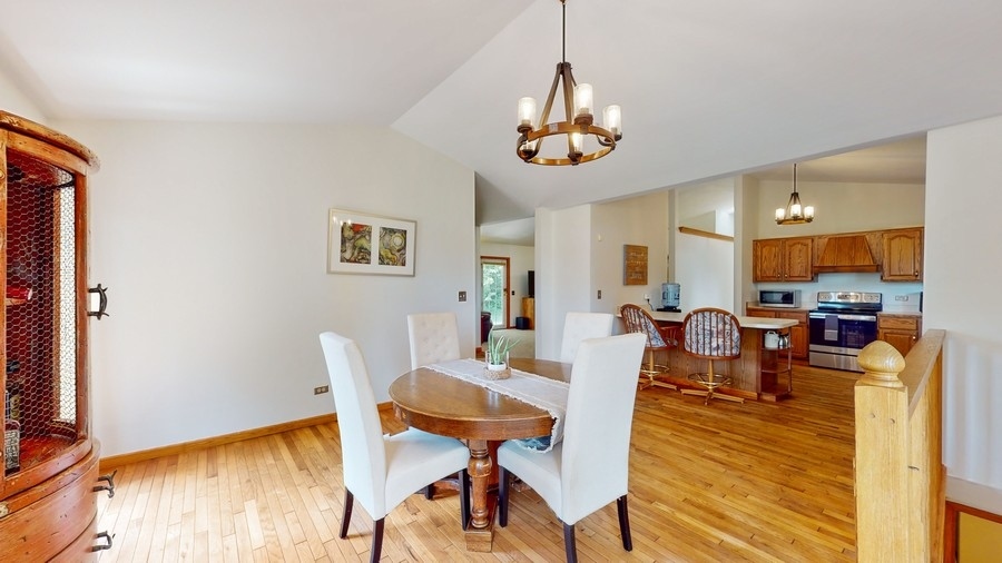 43375 Hunt Club Road Zion, IL 60099 - Photo 7 of 56 a view of a dining room with furniture window and wooden floor