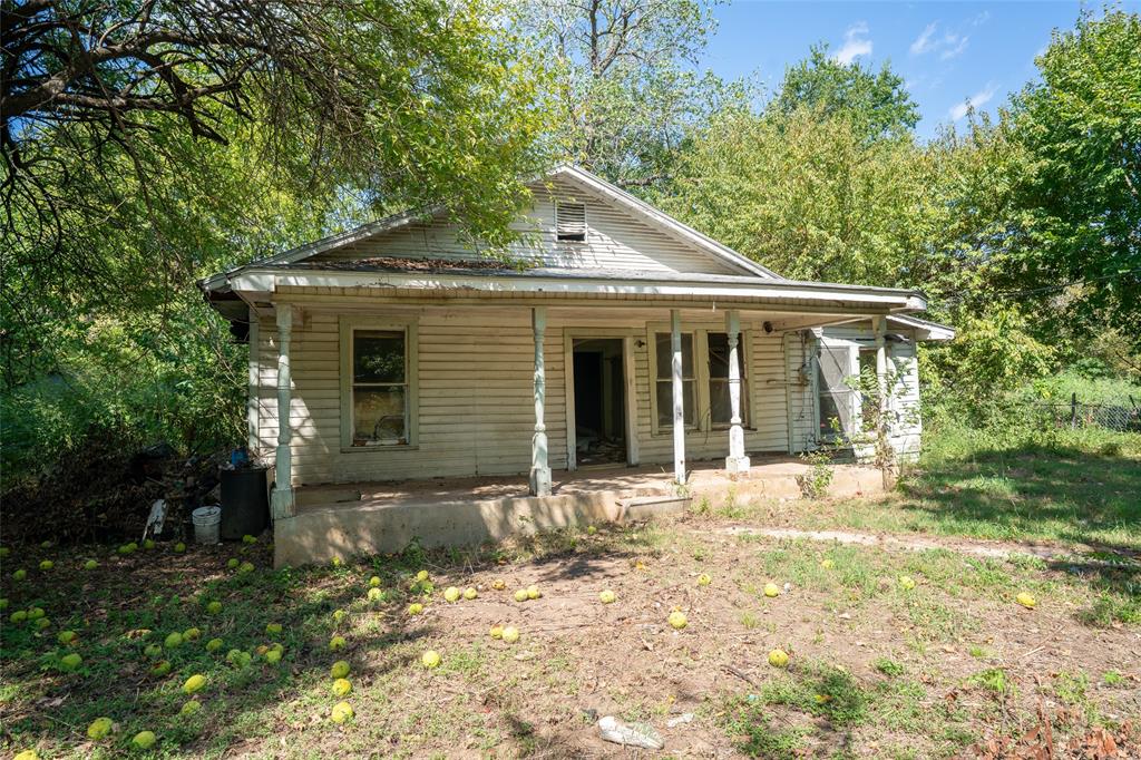 1310 Campbell Street Paris, TX 75460 - Photo 2 of 11 a front view of a house with a yard and garage