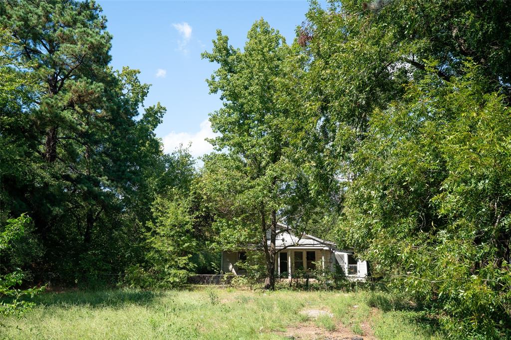 1310 Campbell Street Paris, TX 75460 - Photo 9 of 11 a front view of a house with a yard