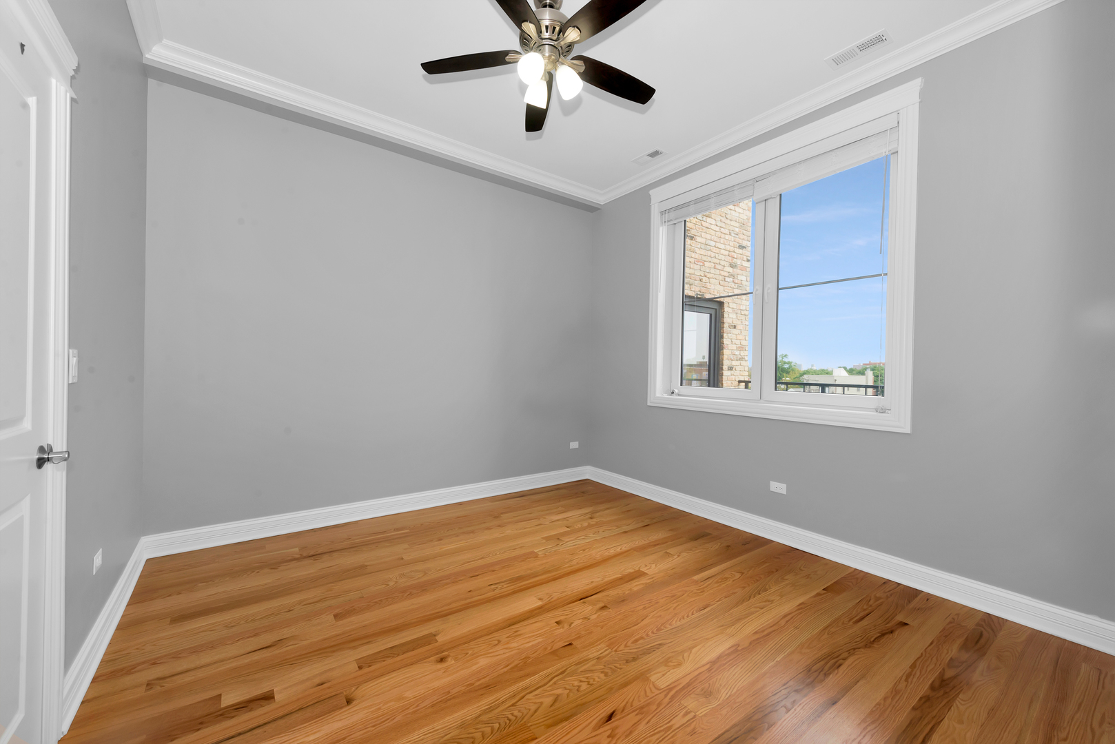 520 North Western Avenue, Unit 4B Chicago, IL 60612 - Photo 33 of 35 a view of an empty room with window and wooden floor