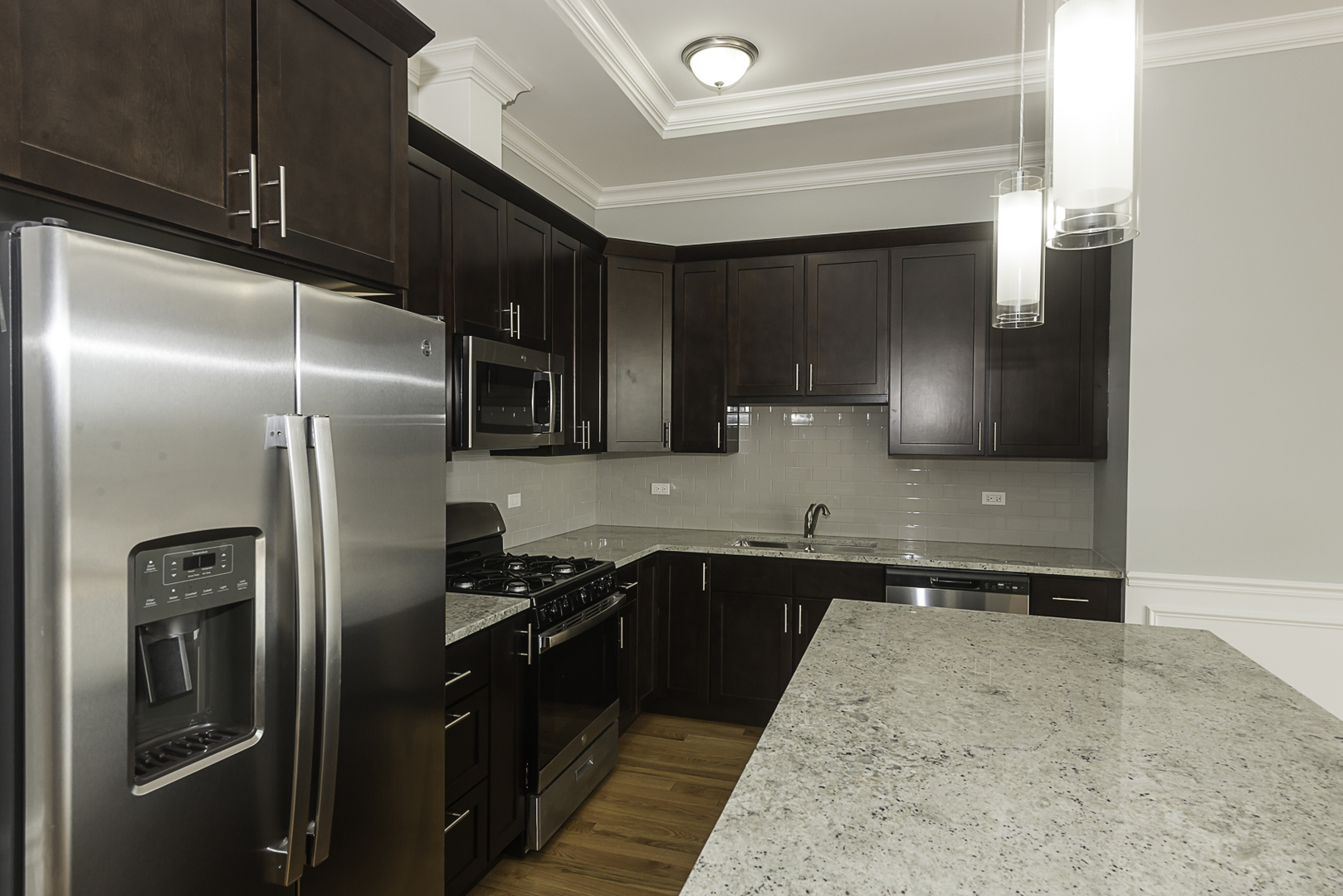 520 North Western Avenue, Unit 4B Chicago, IL 60612 - Photo 4 of 35 a kitchen with stainless steel appliances granite countertop a refrigerator and a sink