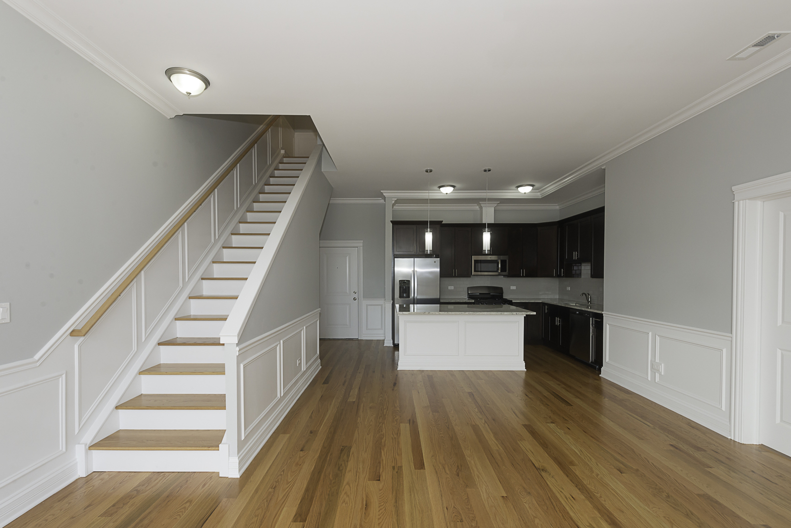 520 North Western Avenue, Unit 4B Chicago, IL 60612 - Photo 6 of 35 a kitchen with a white cabinets and wooden floor