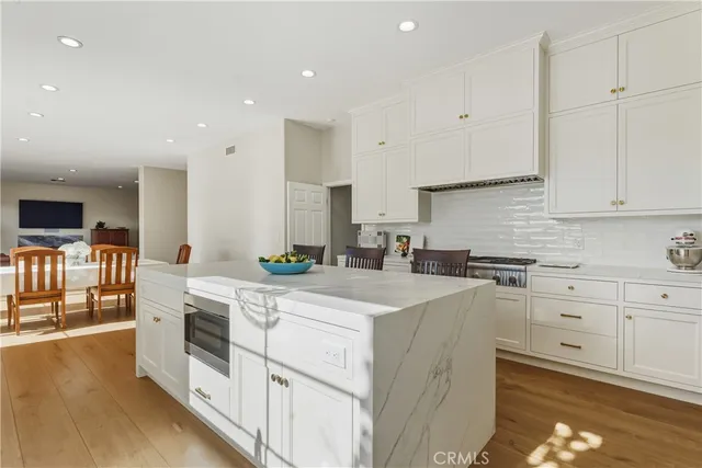 a living room with furniture a flat screen tv and a rug