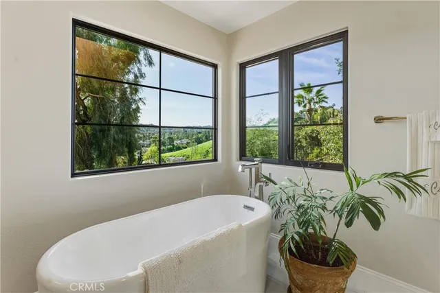 a bathroom with a sink a mirror a vanity and a shower