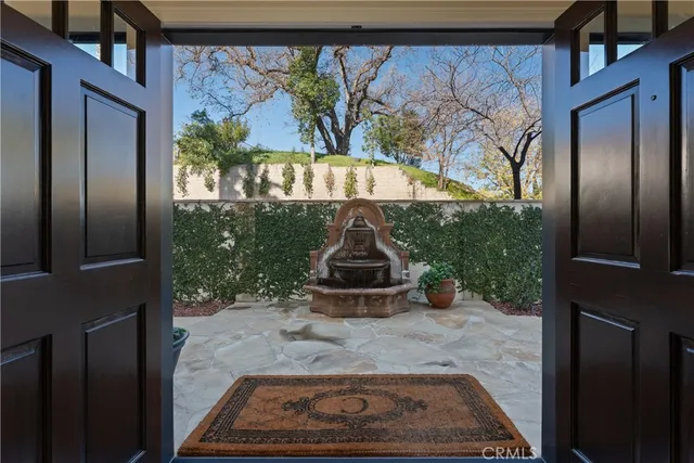 a kitchen with stainless steel appliances granite countertop a stove a sink dishwasher and a dining table with wooden floor