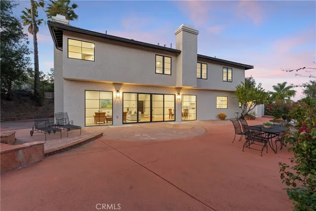 a front view of a house with a garden and yard