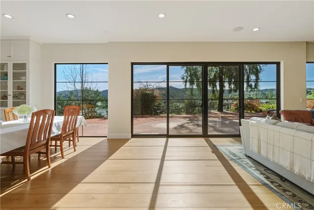 a room with stainless steel appliances kitchen island granite countertop a table chairs sink and cabinets