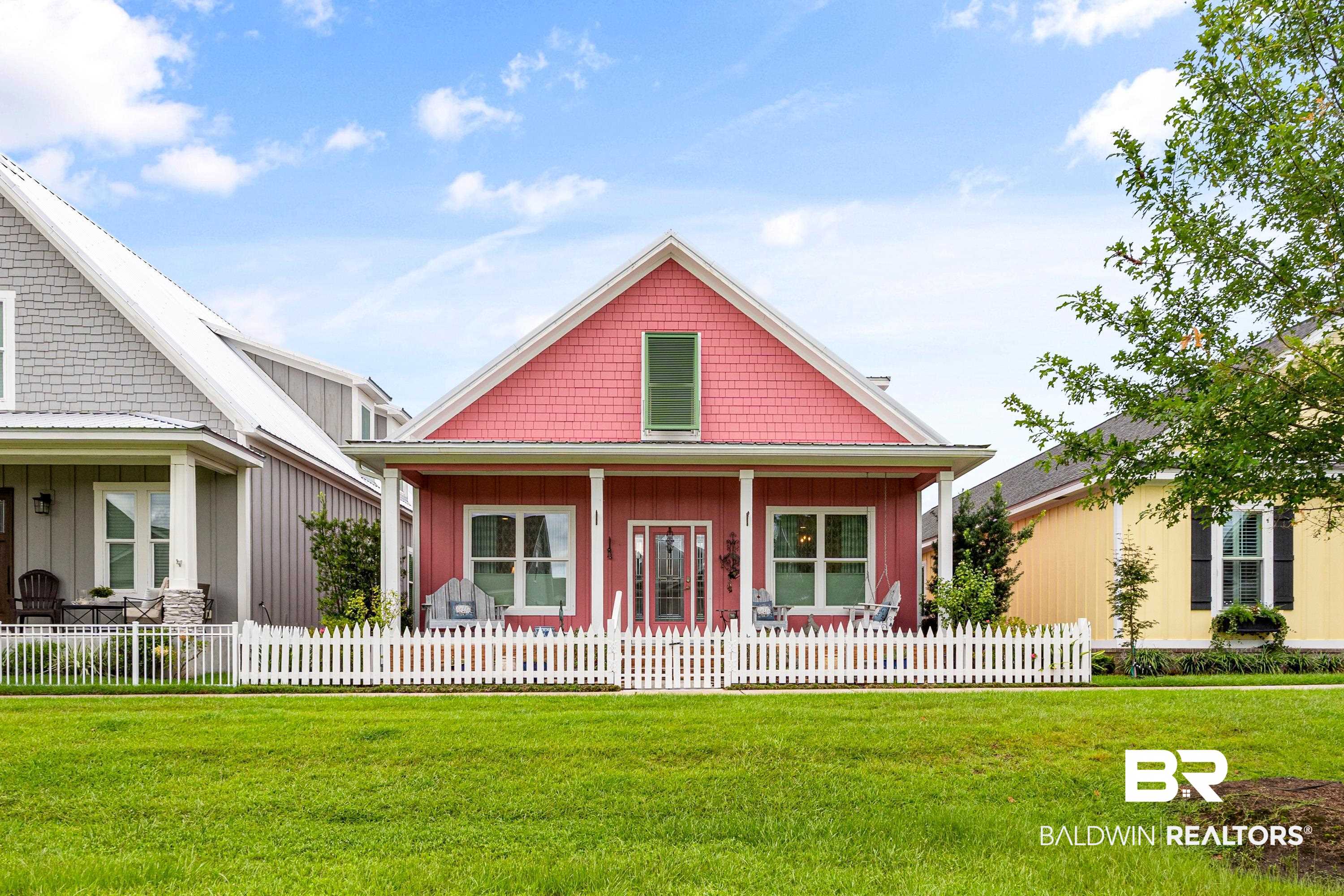 1113 Yellow Daisy Lane Foley, AL 36535 - Photo 2 of 35 View of front of property featuring covered porch, a fenced front yard, and board and batten siding
