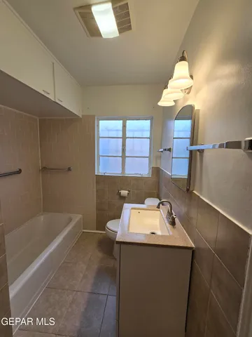 a bathroom with a sink a toilet and bathtub