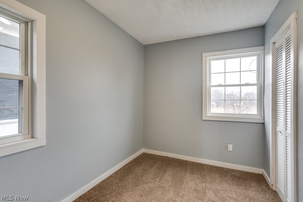 1607 9th Street Southwest Canton, OH 44706 - Photo 33 of 41 Room featuring neutral gray walls and light brown carpeting