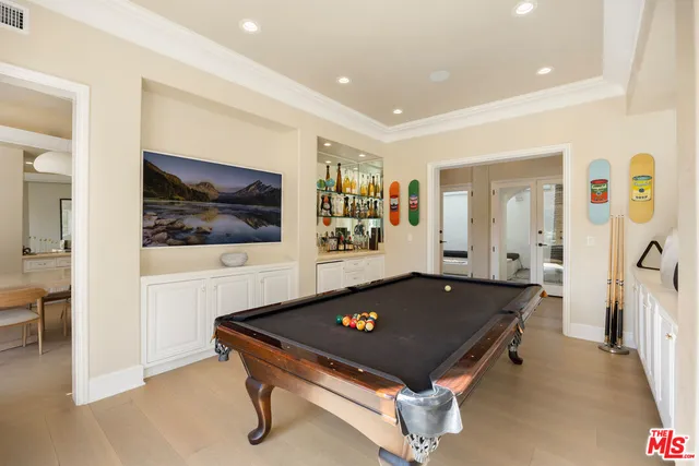 a living room with pool table and a flat screen tv