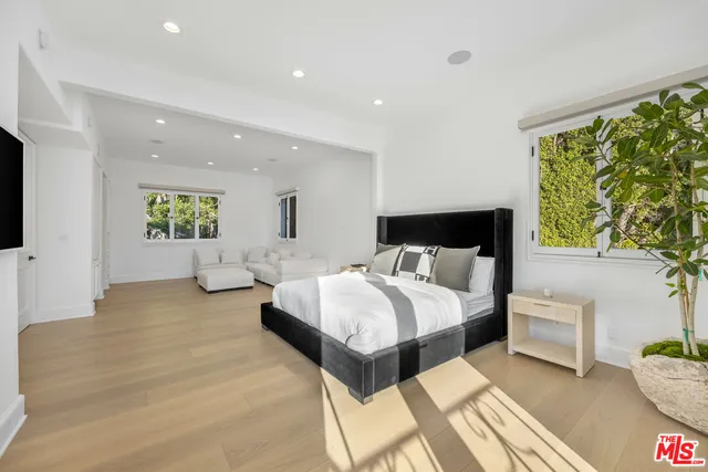 a spacious bedroom with a bed and a couch