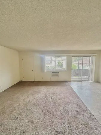a kitchen with stainless steel appliances a stove a sink and white cabinets
