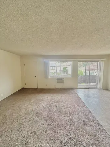 a kitchen with stainless steel appliances a stove a sink and white cabinets