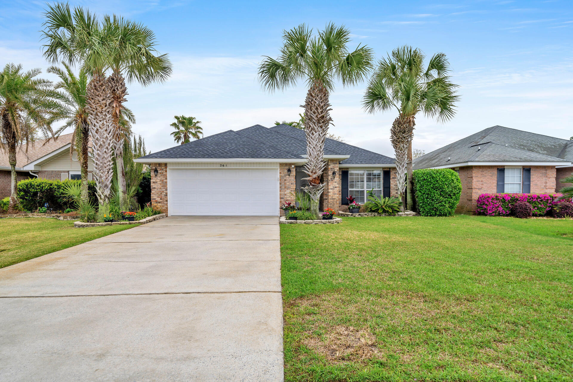 a front view of house with yard and green space