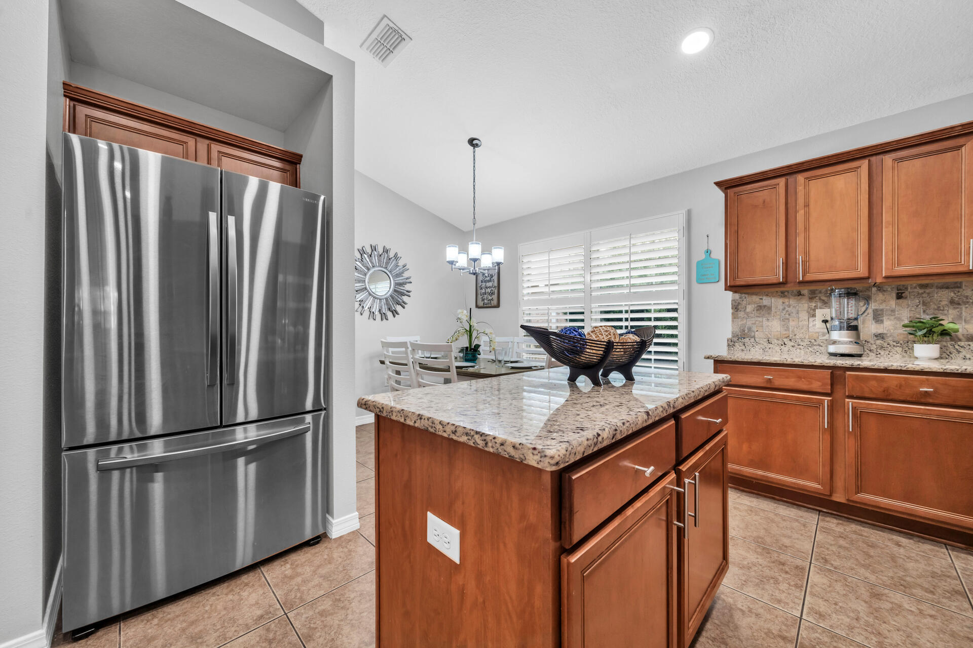 261 Sandy Cay Drive Miramar Beach, FL 32550 - Photo 17 of 72 a kitchen with stainless steel appliances granite countertop a refrigerator a sink dishwasher a kitchen island with wooden cabinets and floor
