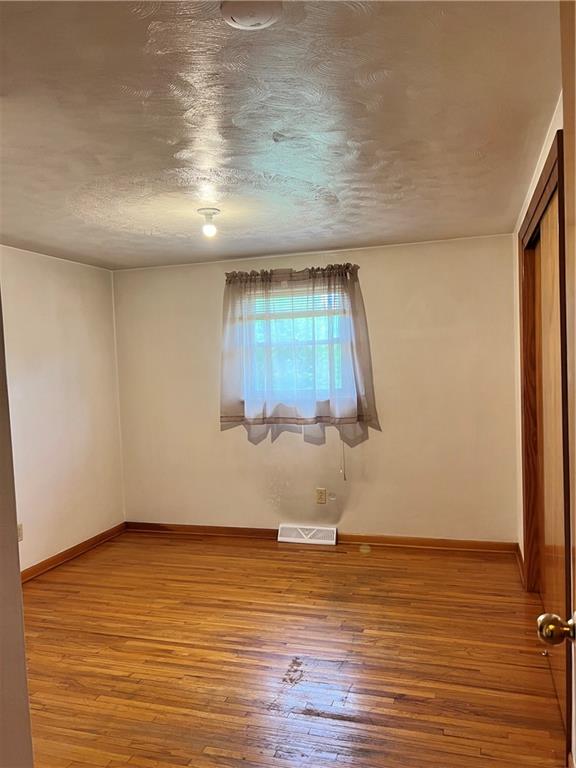 880 Pizza Barn Road Blairsville, PA 15717 - Photo 13 of 44 an empty room with wooden floor and windows