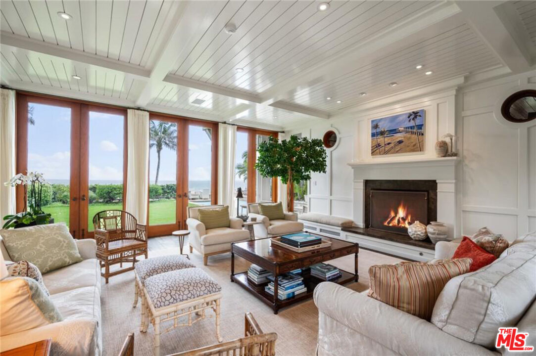 212 The Strand Manhattan Beach, CA 90266 - Photo 11 of 74 a living room with furniture a fireplace and a large window