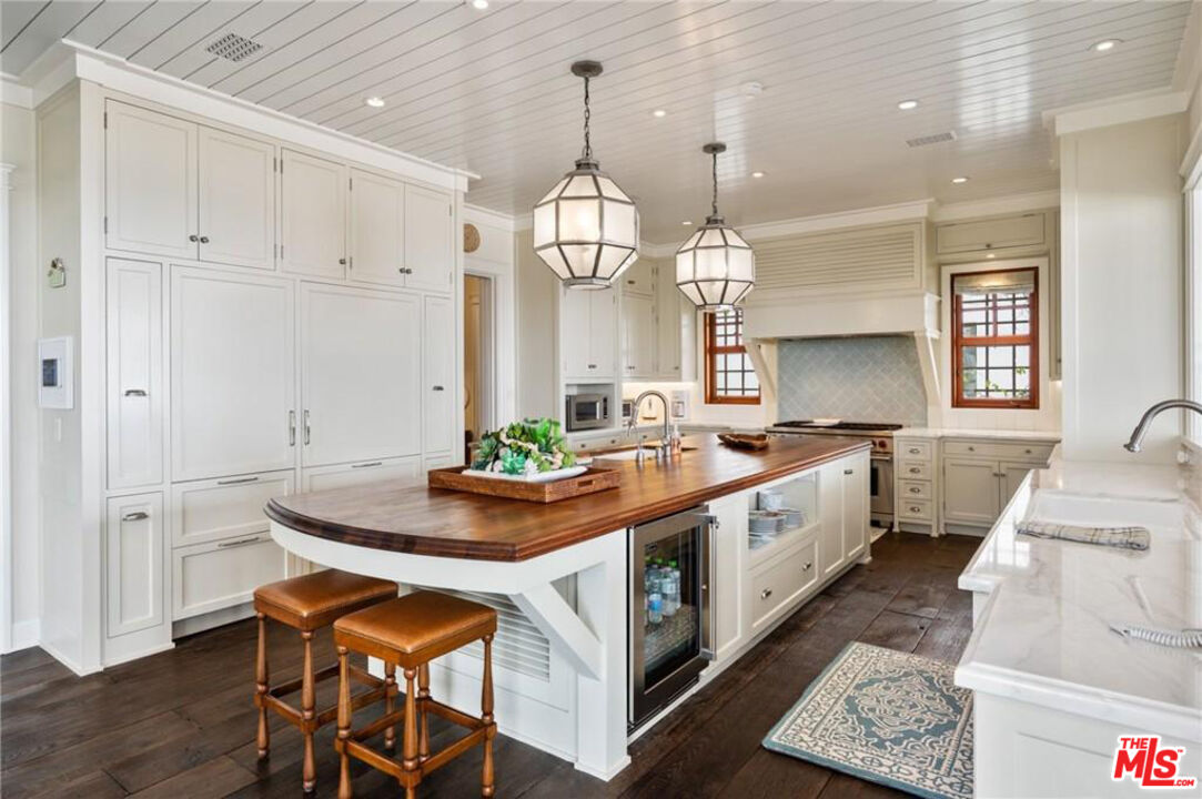 212 The Strand Manhattan Beach, CA 90266 - Photo 18 of 74 a large white kitchen with sink and dishwasher