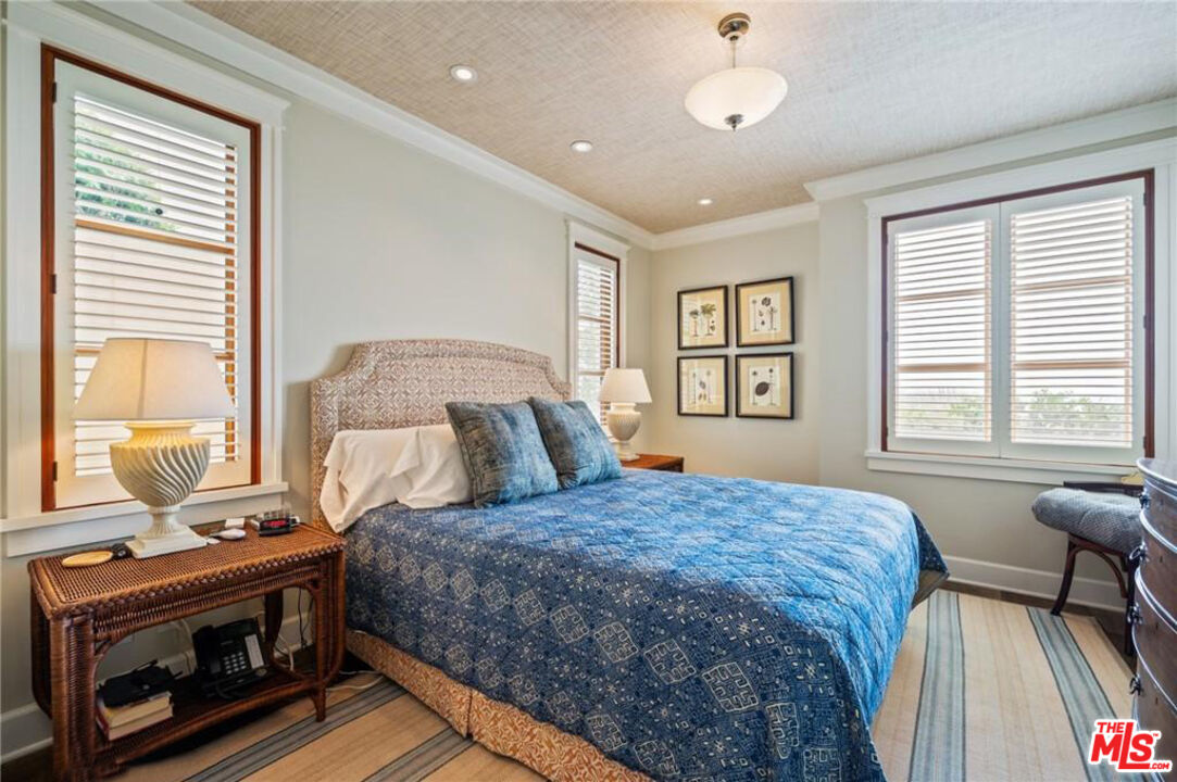 212 The Strand Manhattan Beach, CA 90266 - Photo 34 of 74 a bedroom with a bed next to a window