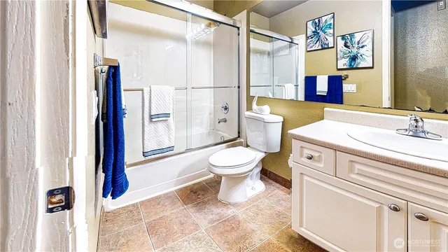 a bathroom with a toilet sink and a shower