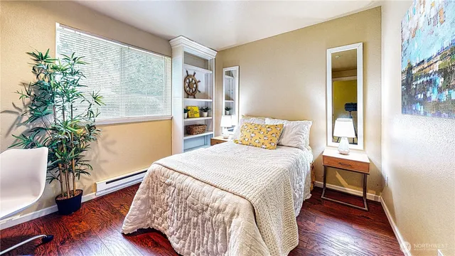 a bedroom with a bed and a potted plant