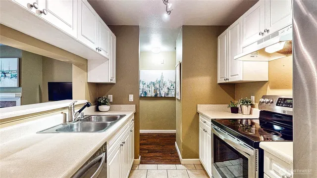a kitchen with a sink stove top oven and cabinets