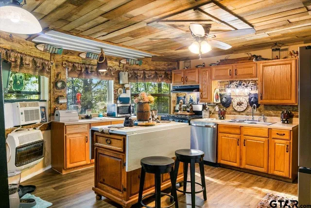 a kitchen with stove a sink and refrigerator