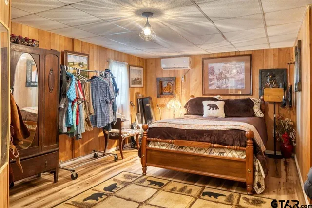 a spacious bedroom with a bed and glass windows