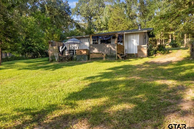 a backyard of a house with table and chairs