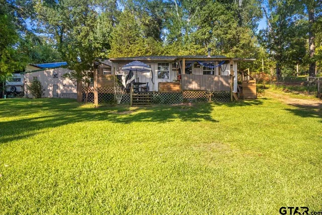 a front view of a house with a yard table and chairs
