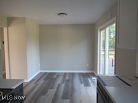 6439 Wadsworth Road Medina, OH 44256 - Photo 8 of 14 Unfurnished dining area with dark wood-style floors and baseboards