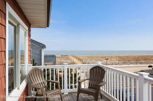 a view of a balcony dining table and chairs