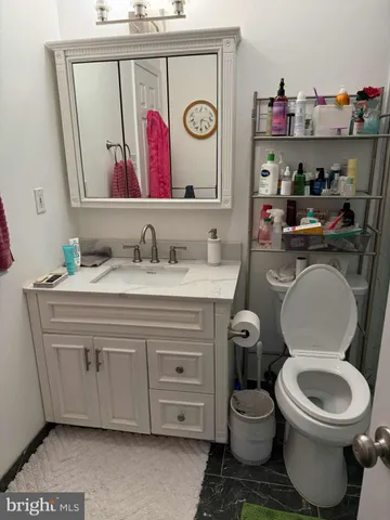 a bathroom with a toilet a sink and a mirror