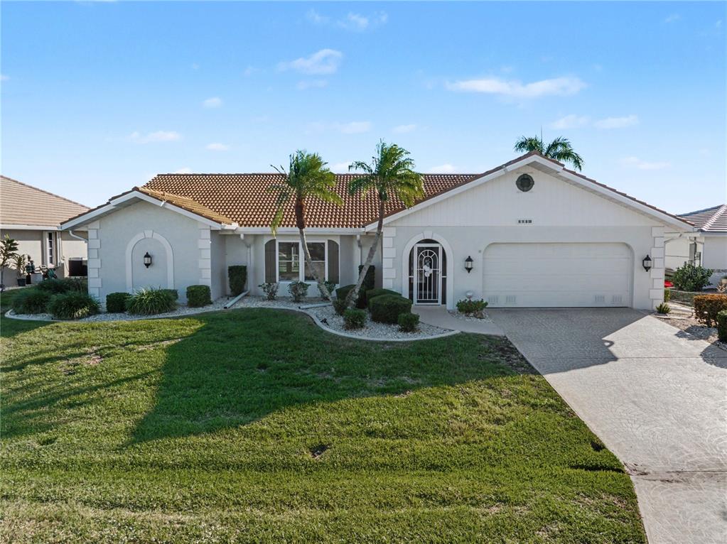 1119 Vía Formia Punta Gorda, FL 33950 - Photo 1 of 58 a front view of a house with a yard