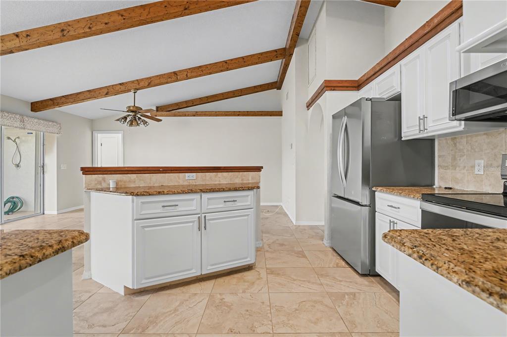 1119 Vía Formia Punta Gorda, FL 33950 - Photo 26 of 58 a kitchen with stainless steel appliances granite countertop a stove a sink and a refrigerator