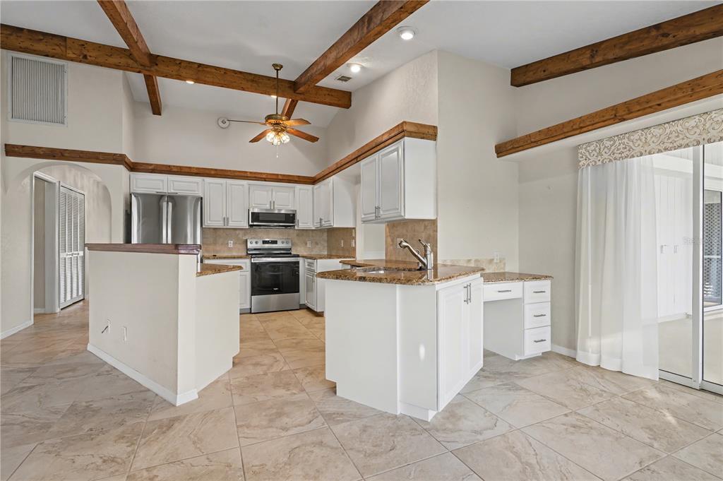 1119 Vía Formia Punta Gorda, FL 33950 - Photo 28 of 58 a kitchen with cabinets and wooden floor