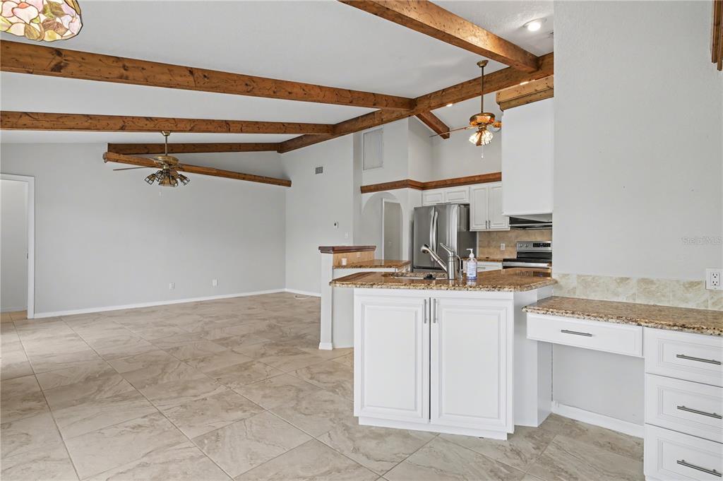 1119 Vía Formia Punta Gorda, FL 33950 - Photo 29 of 58 a kitchen with a stove and a white cabinets