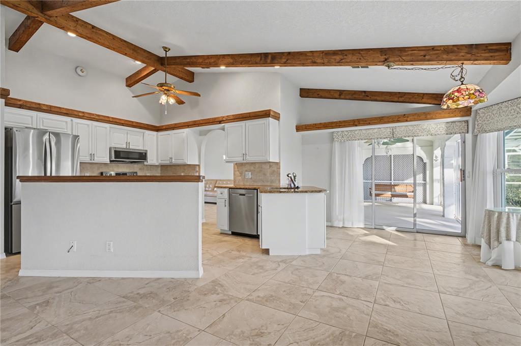 1119 Vía Formia Punta Gorda, FL 33950 - Photo 30 of 58 a kitchen with stainless steel appliances granite countertop a stove top oven a sink a counter top space and cabinets
