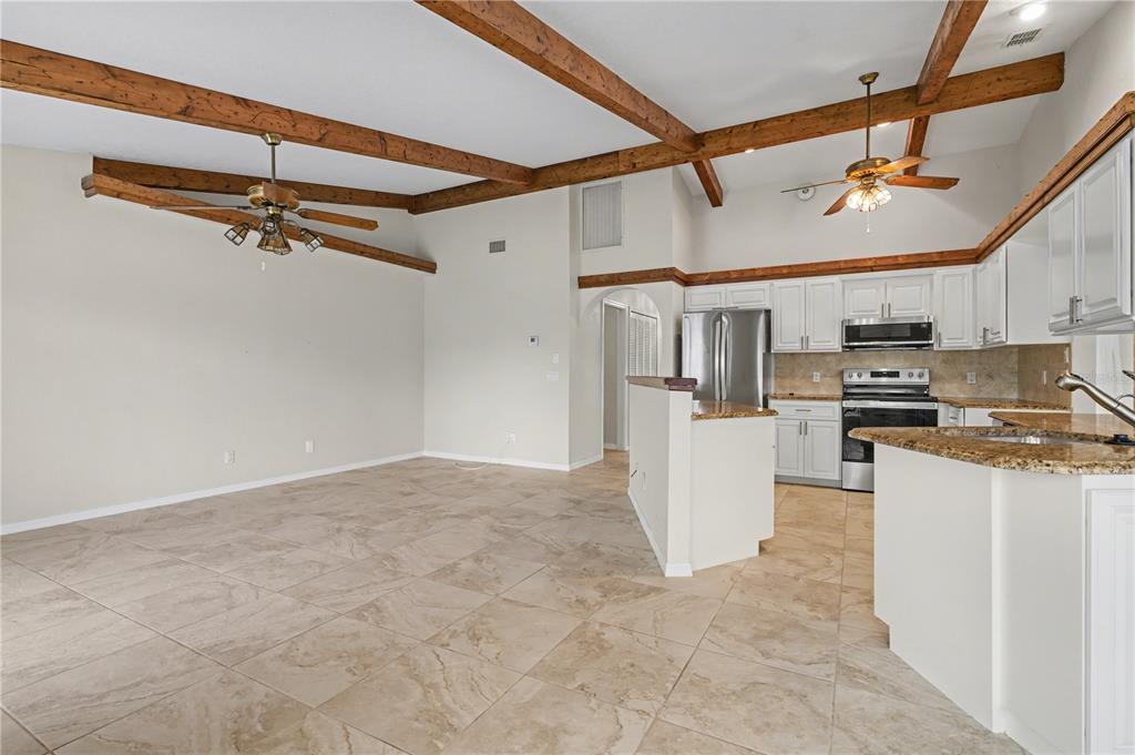 1119 Vía Formia Punta Gorda, FL 33950 - Photo 32 of 58 a view of a kitchen with furniture and a ceiling fan