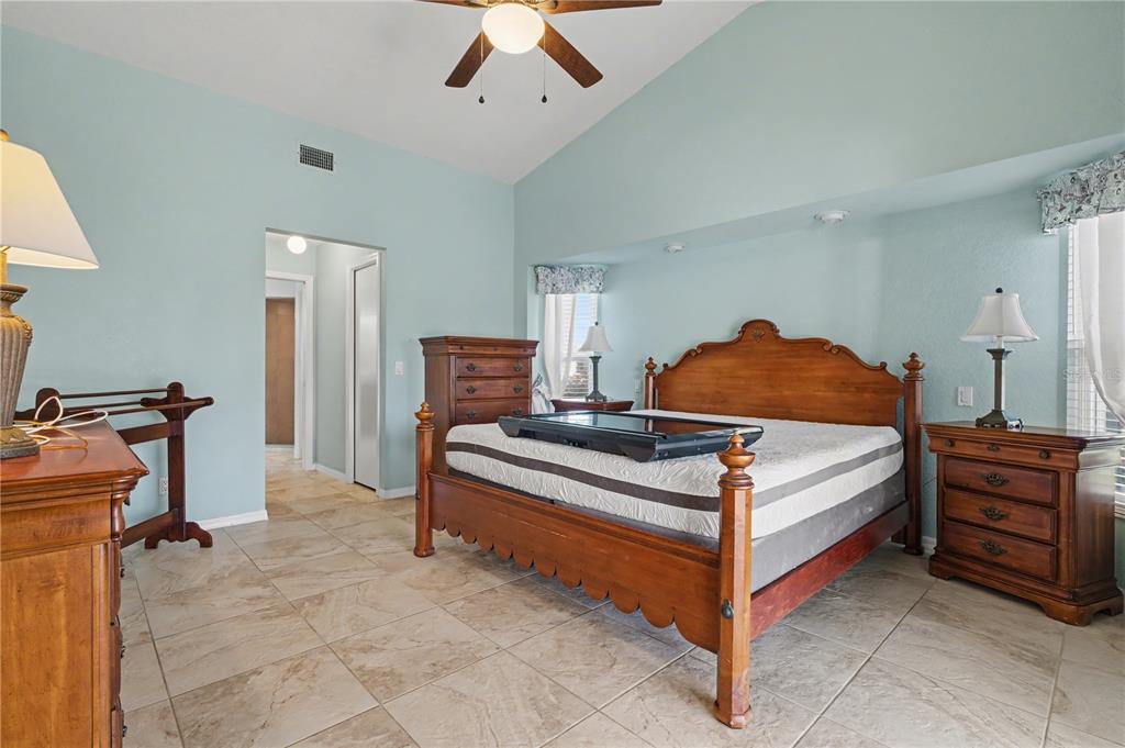 1119 Vía Formia Punta Gorda, FL 33950 - Photo 35 of 58 a bedroom with a bed and a chandelier