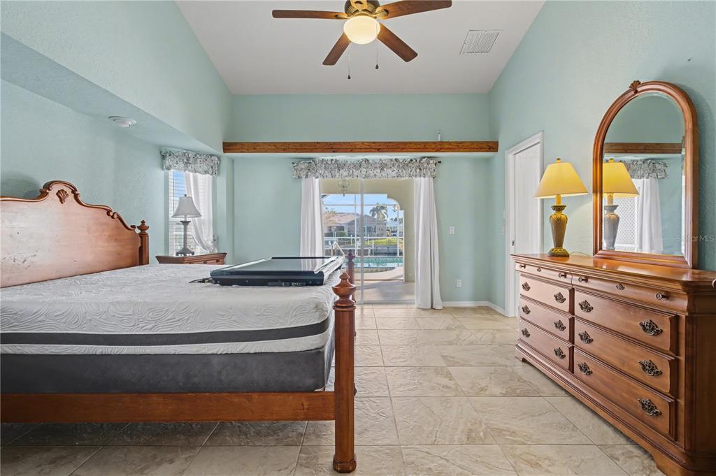 1119 Vía Formia Punta Gorda, FL 33950 - Photo 37 of 58 a bedroom with a large bed and a large window