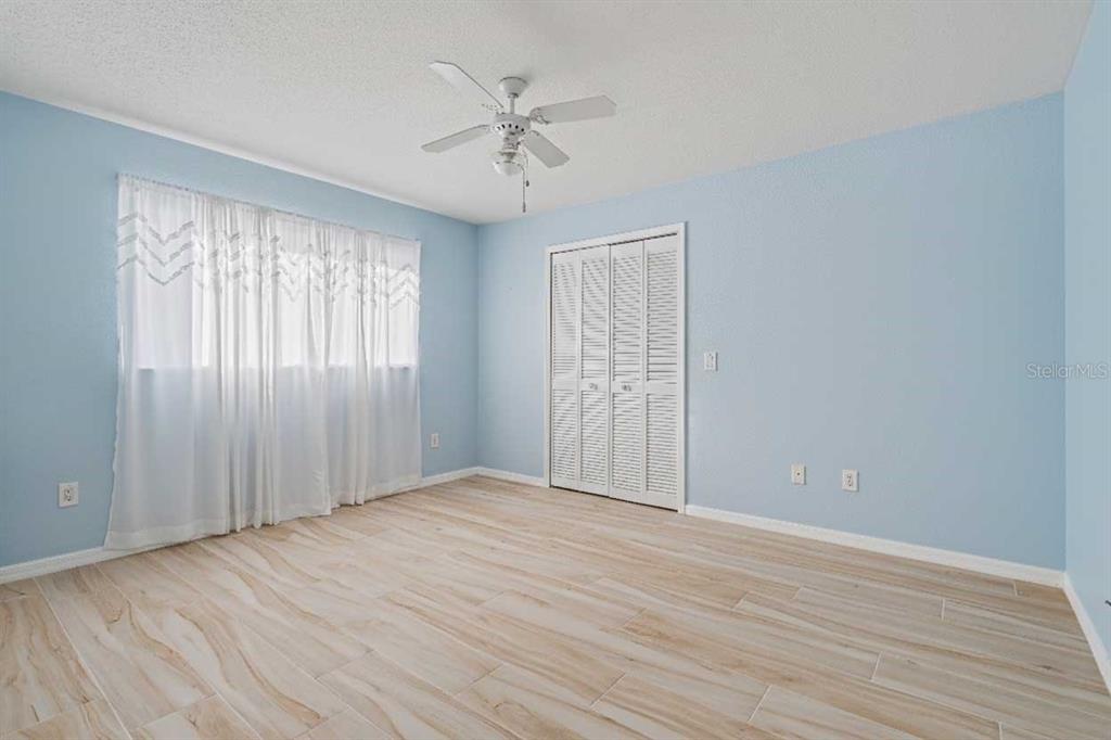 1119 Vía Formia Punta Gorda, FL 33950 - Photo 40 of 58 wooden floor in an empty room with a window