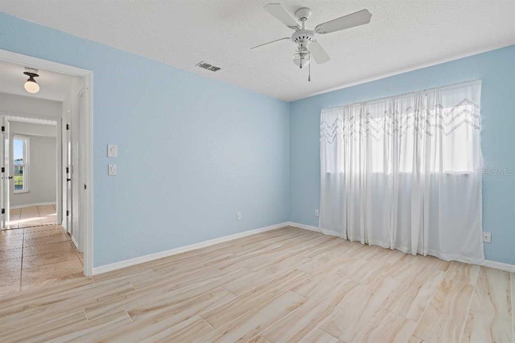 1119 Vía Formia Punta Gorda, FL 33950 - Photo 41 of 58 a view of an empty room with wooden floor and a window