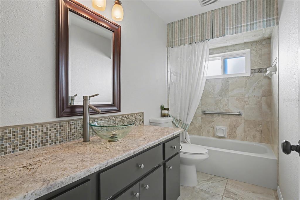 1119 Vía Formia Punta Gorda, FL 33950 - Photo 42 of 58 a bathroom with a granite countertop sink toilet and shower