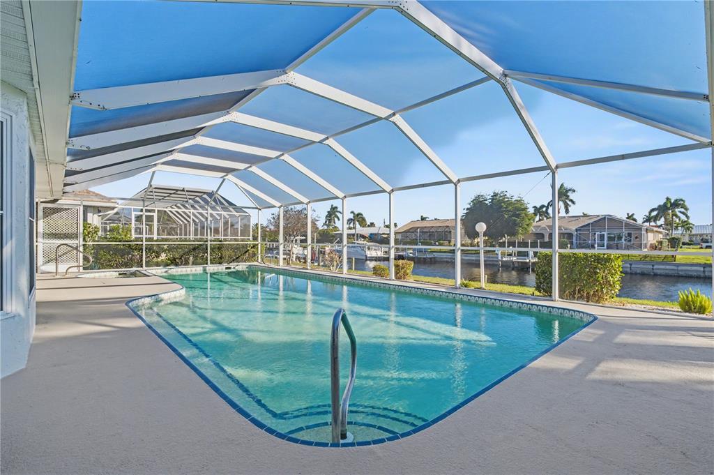 1119 Vía Formia Punta Gorda, FL 33950 - Photo 6 of 58 a view of a swimming pool with a porch next to a yard
